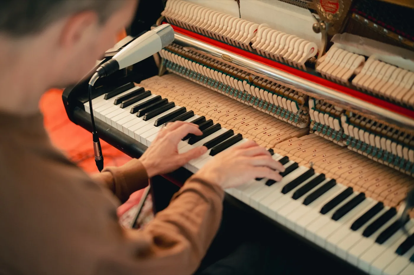 At the upright piano